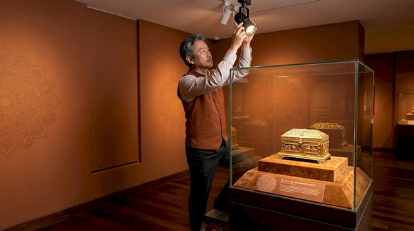 Curator adjusts light on Buddhist reliquary
