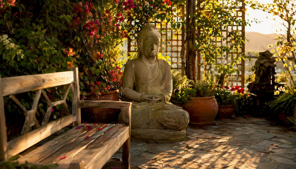 Stone Buddha statue in serene garden outdoors