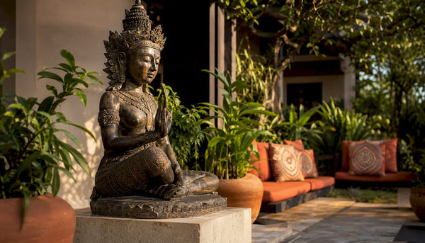 Asian sculpture on pedestal in boutique hotel lobby