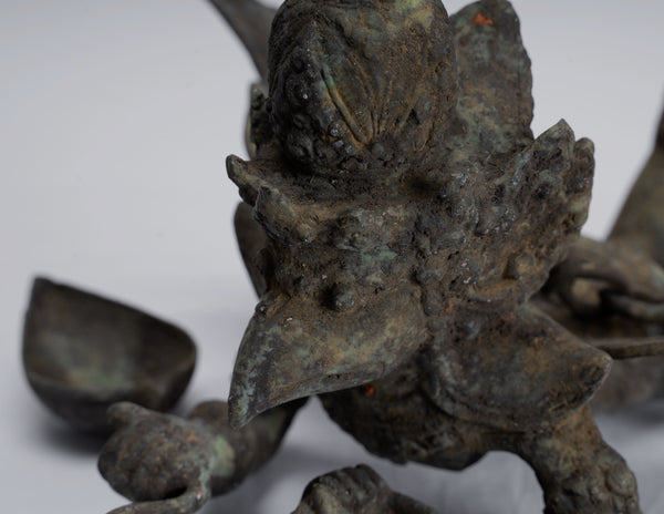 Unveiling the Symbolism: The Profound Significance of the Indonesian Garuda Holding a Trident and Sword, Standing on a Snake