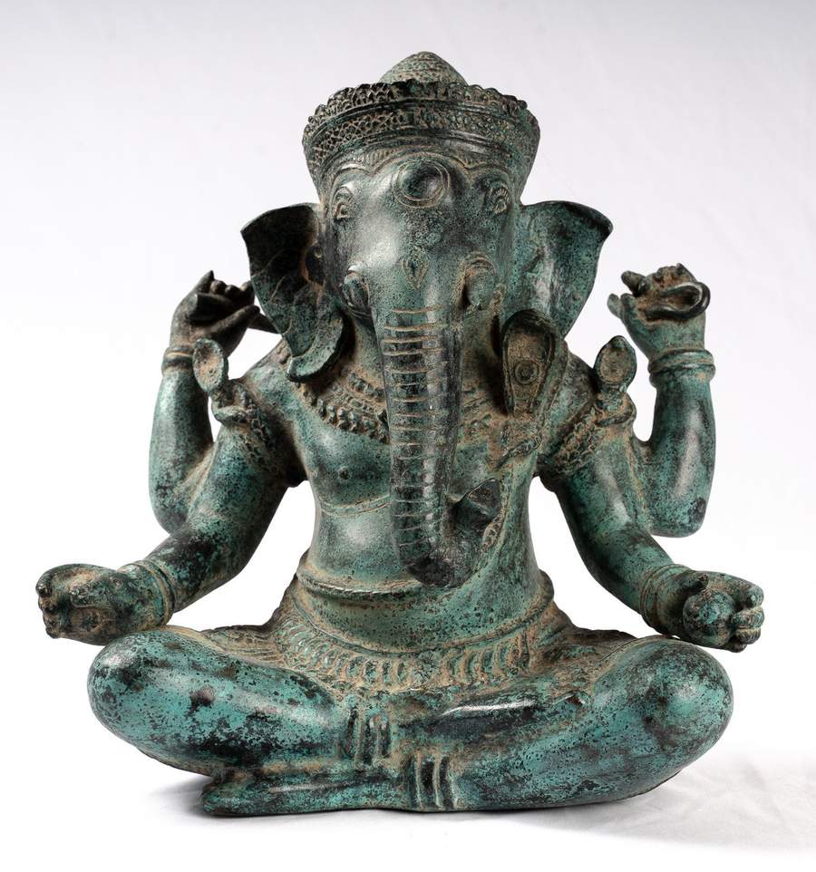 Bronze statue of a seated Ganesh with four arms, intricate detailing on the head and body.